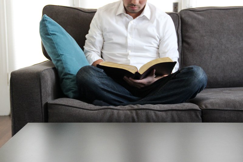 man-couch-reading-bible